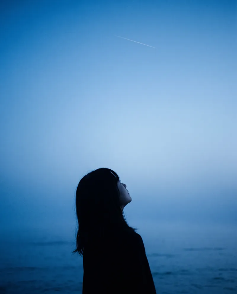 Profile Silhouette Against Blue Sea Mist — AI-generated photograph