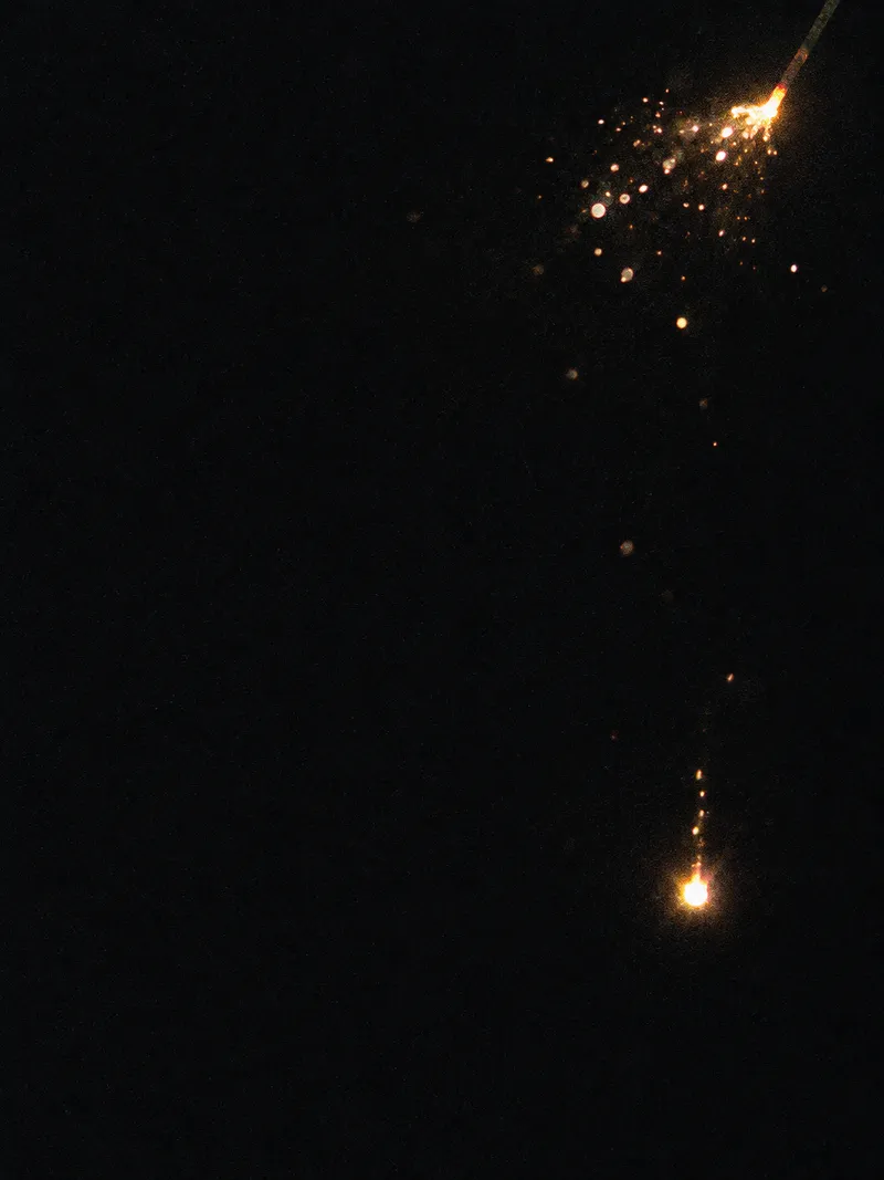 Falling Sparkler Ember in the Dark — AI-generated photograph