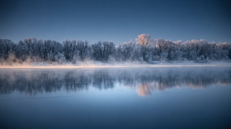 Frost-Covered Bare Trees Mirrored in a Frozen River — AI-generated photograph