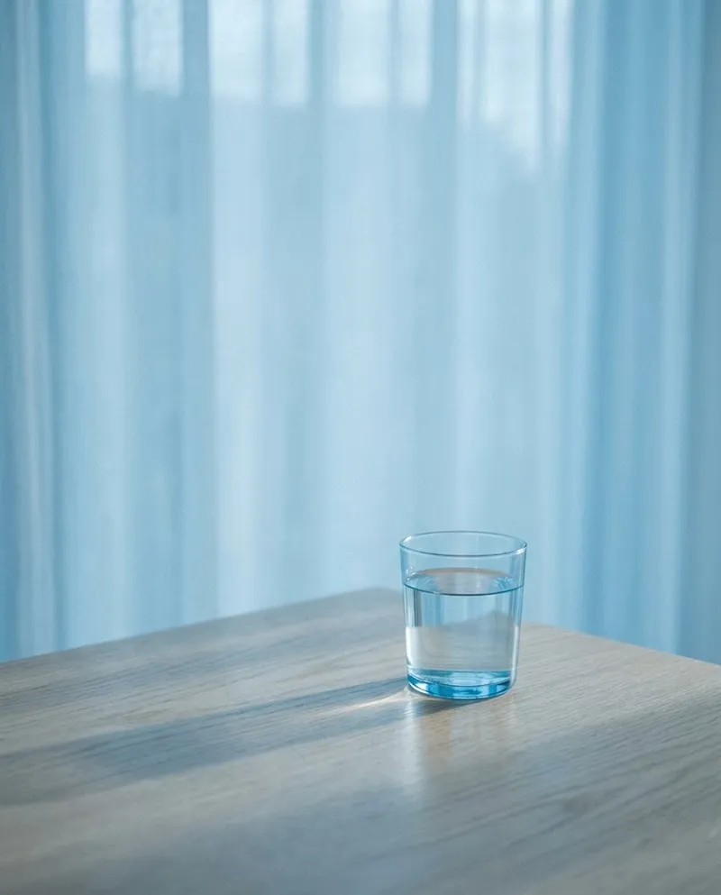 Water Glass on a Light Oak Table — AI-generated photograph