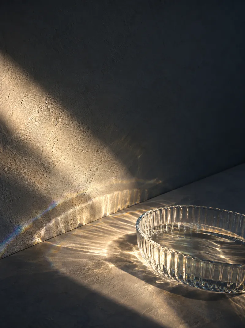 Ribbed Glass Bowl Casting Curved Light — AI-generated photograph
