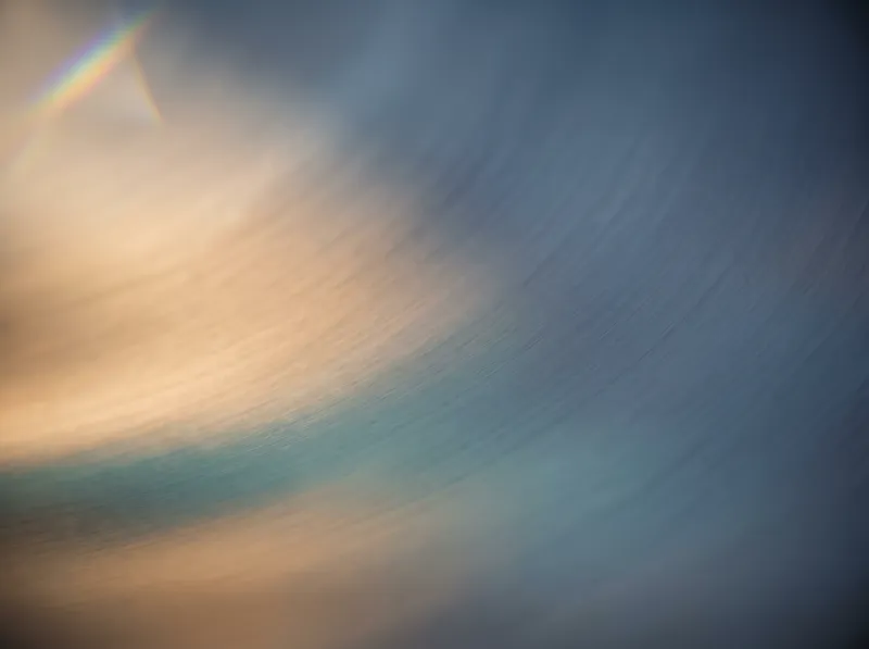 Amber and Teal Light Streaked on Brushed Metal — AI-generated photograph