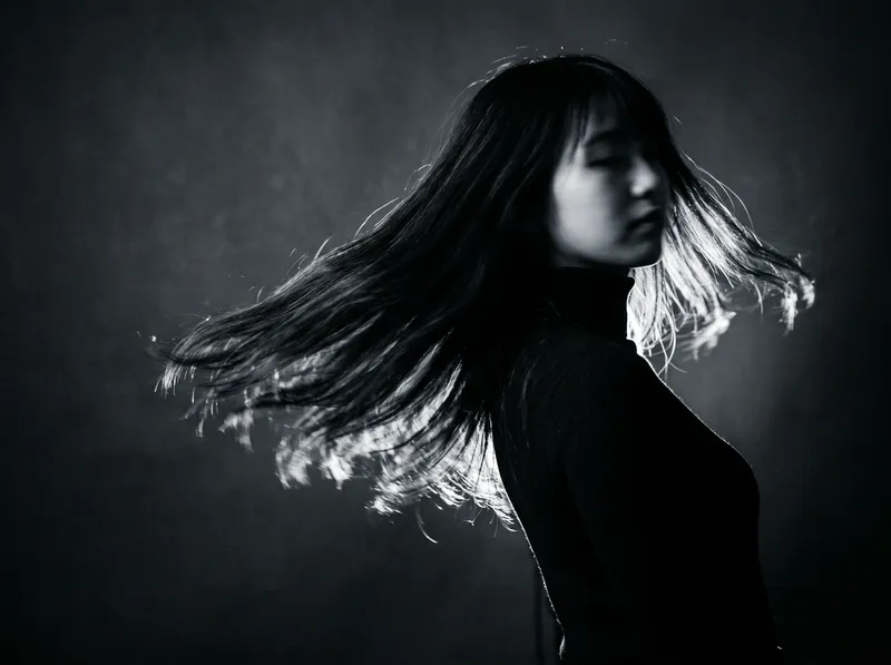 Woman Turning with Hair Sweeping in Monochrome — AI-generated photograph