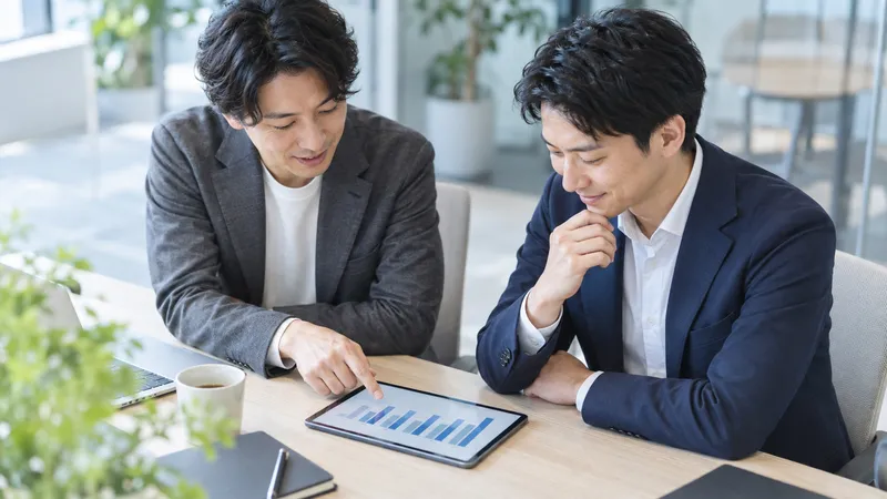 Colleagues Viewing a Tablet Together — AI-generated photograph