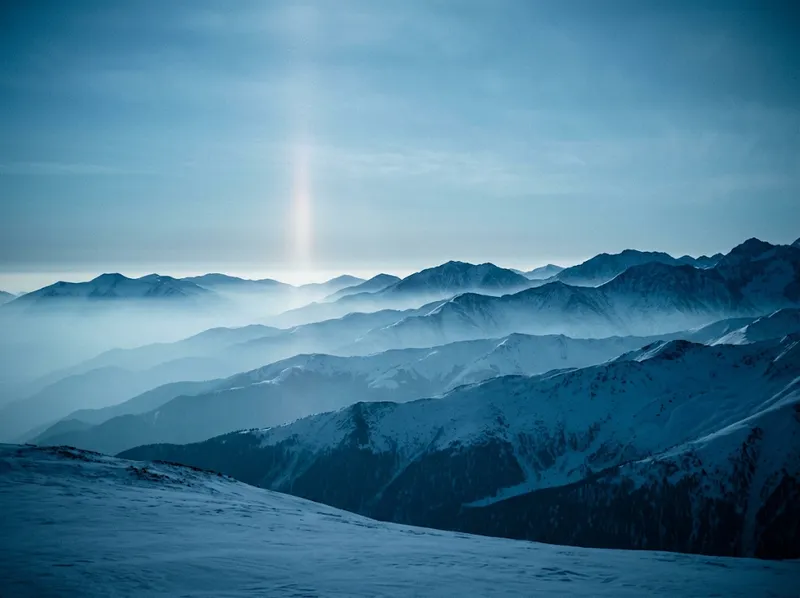 Snow-Covered Layered Ridges in Cool Mist — AI-generated photograph