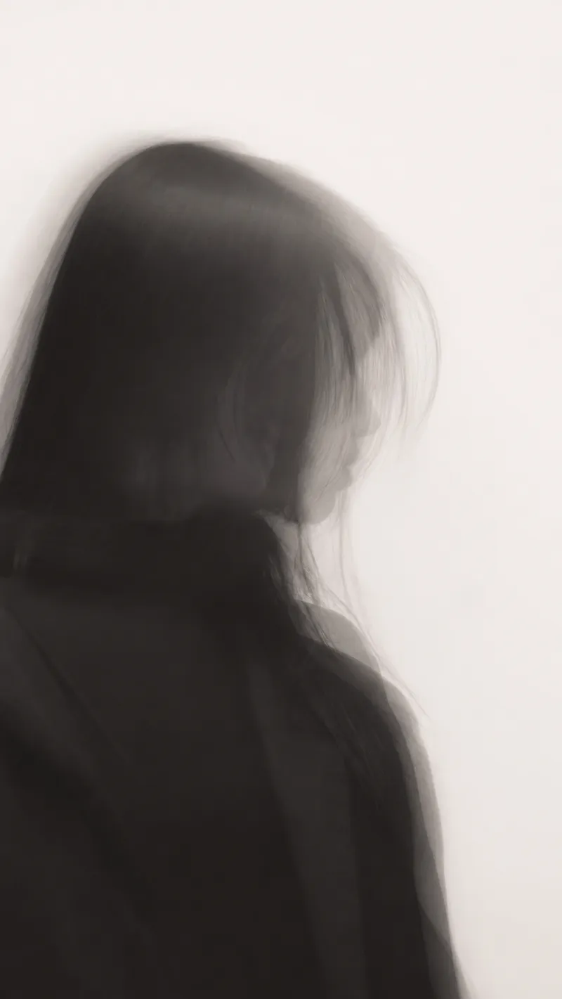 Motion-Blurred Profile of a Woman in Black with Long Exposure — AI-generated photograph