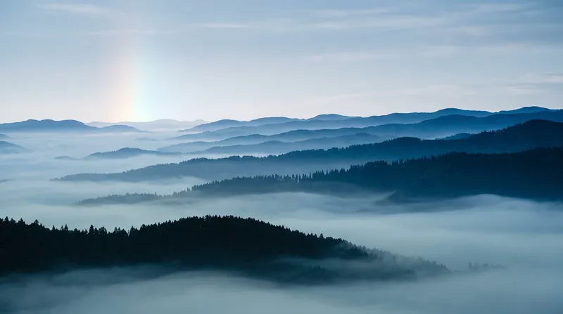 Layered Conifer Ridges in Valley Morning Mist — AI-generated photograph