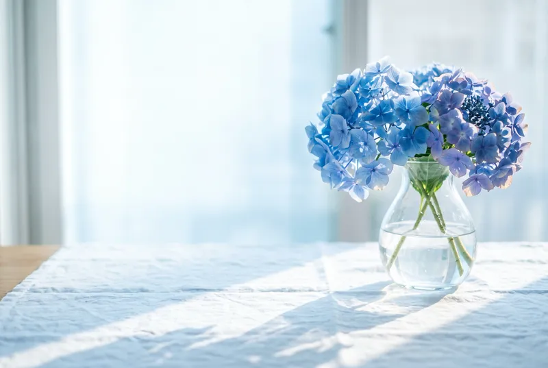 Backlit Blue Hydrangeas in a Glass Vase — AI-generated photograph