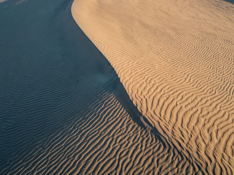 Overhead View of Wind-Rippled Dawn Dunes — AI-generated photograph