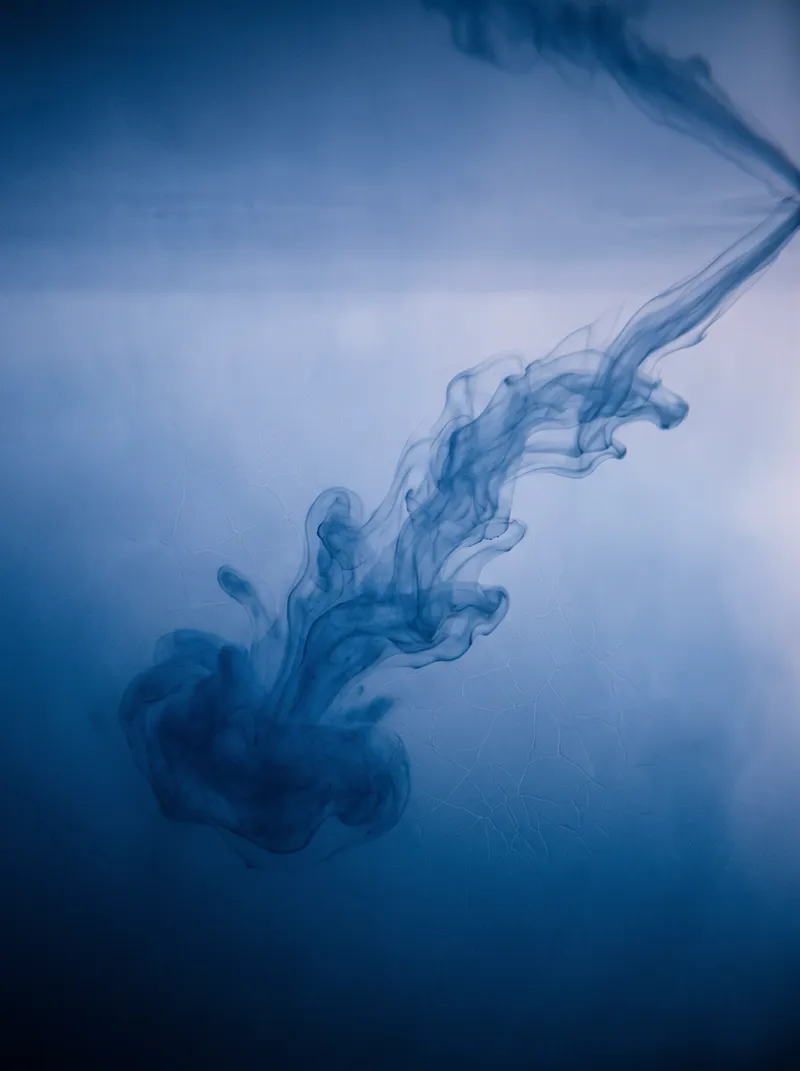 Ink Cloud Sinking Through Misty Blue Water — AI-generated photograph