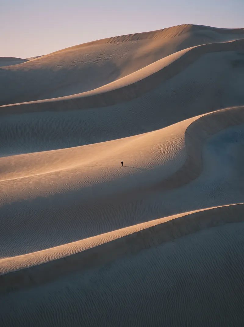 Dawn Light on Wind-Rippled Dune Ridges — AI-generated photograph