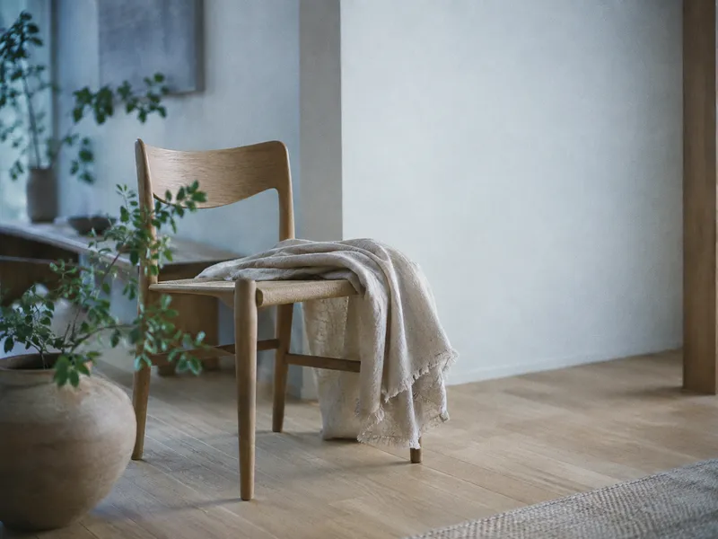 Wooden Chair Against a Pale Interior Wall — AI-generated photograph