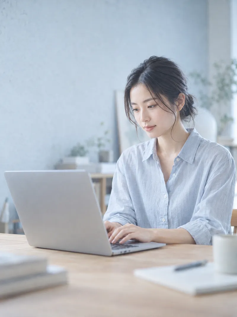 Woman Working on a Laptop in a Bright Studio — AI-generated photograph