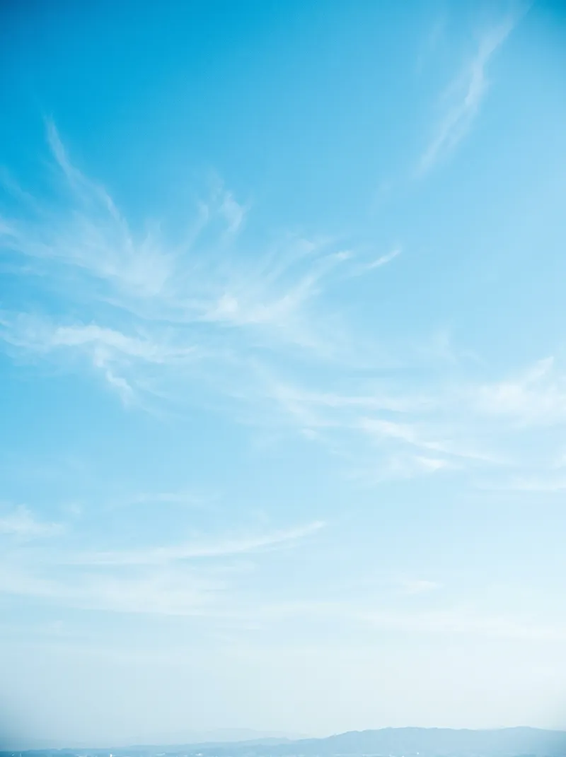 Wispy Cirrus Clouds in a Pale Blue Sky — AI-generated photograph