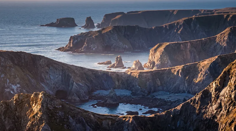 Layered Sea-Cliff Ridges and Sea Stacks in Morning Light — AI-generated photograph