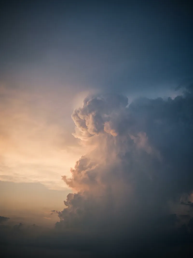 Amber-Lit Cumulus Tower at Dusk — AI-generated photograph